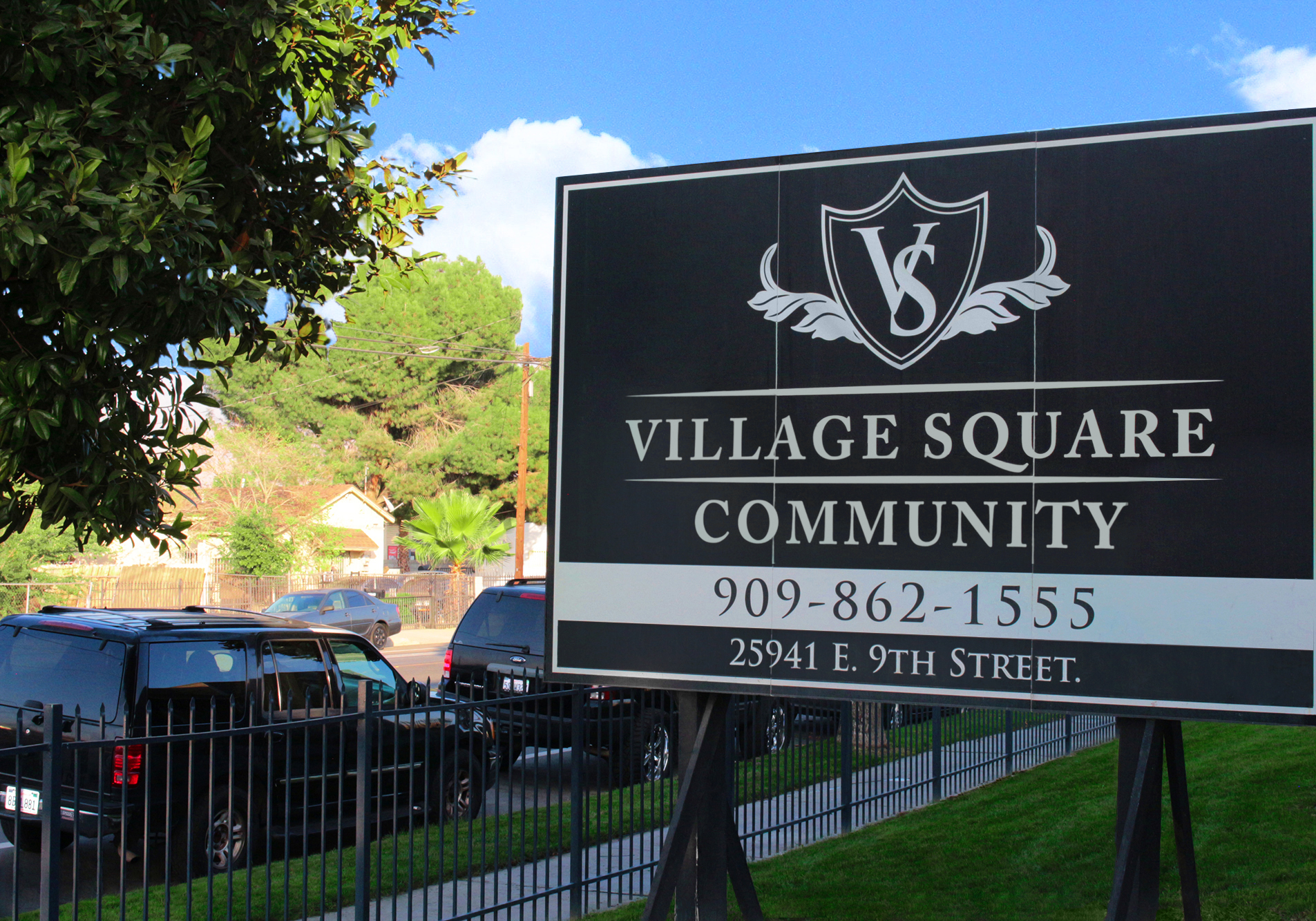 This image displays entrance marker photo of Village Square Apartments