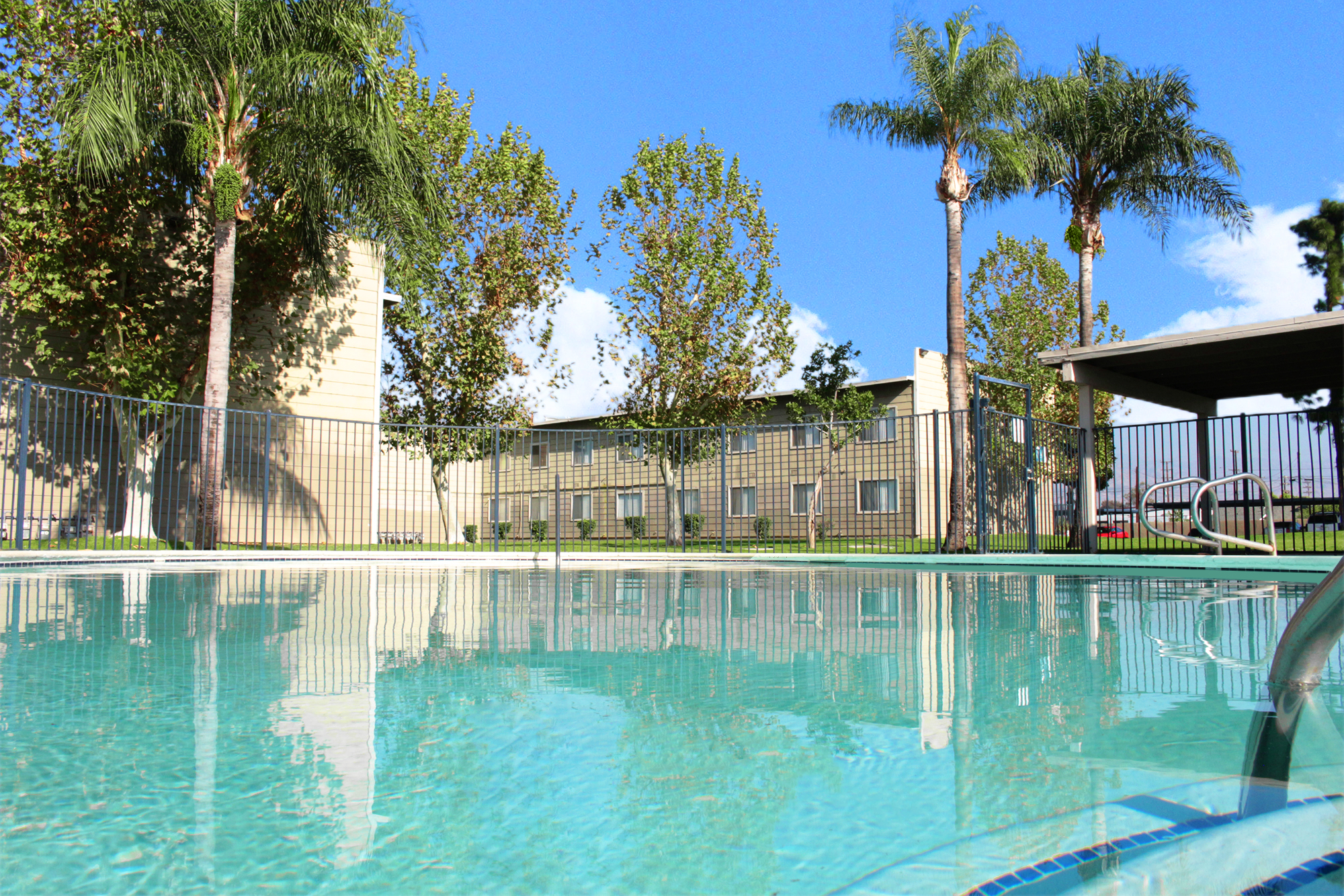 This banner image shows the swimming pool of the Village Square Apartments.